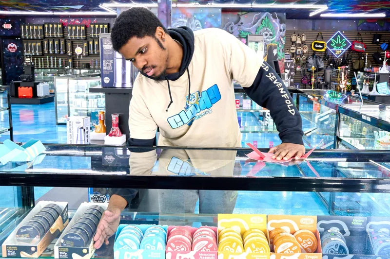 Cloud 9 team member helping behind the store counter
